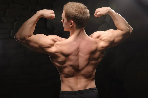 Athletic man on black backgrounds — Stock Photo, Image