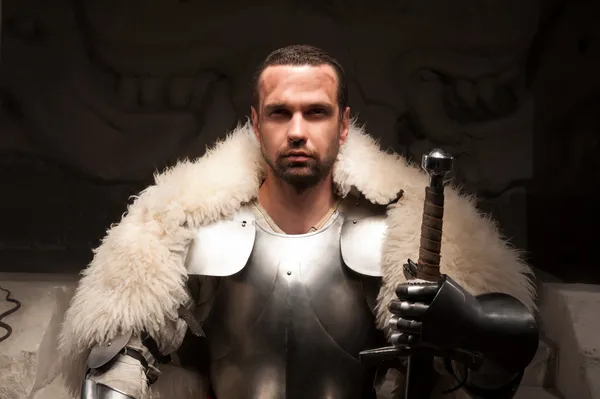 Medieval warrior in armor and fur mantle — Stock Photo, Image