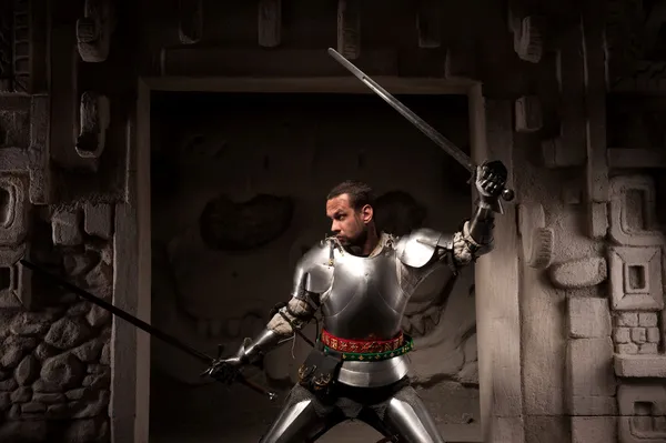 Medieval warrior posing on steps of ancient temple — Stock Photo, Image