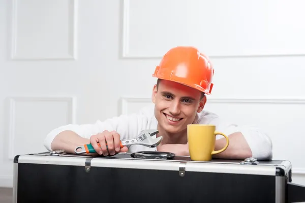 Worker in helmet with coffee cup — Stock Photo, Image