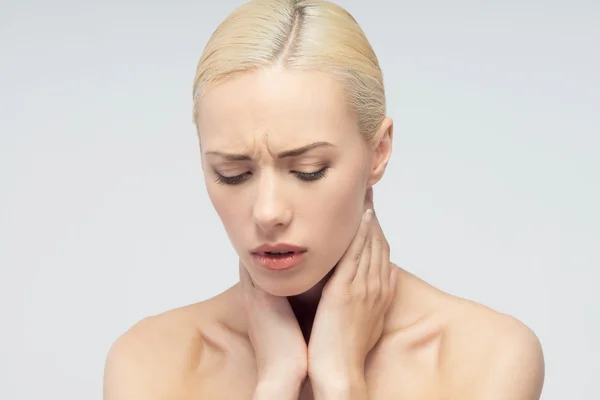 Pain concept. Young woman with touching her throat and head — Stock Photo, Image