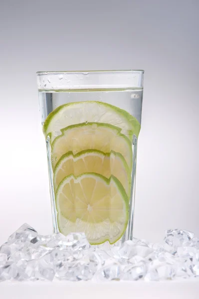 Glass Of Drink With Ice Cubes And Fruits — Stock Photo, Image