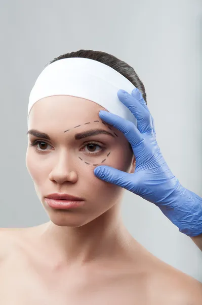 Beautiful young woman with perforation lines on her face before — Stock Photo, Image