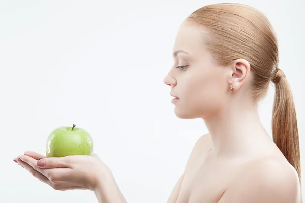 Retrato de una joven atractiva sosteniendo una manzana verde — Foto de Stock