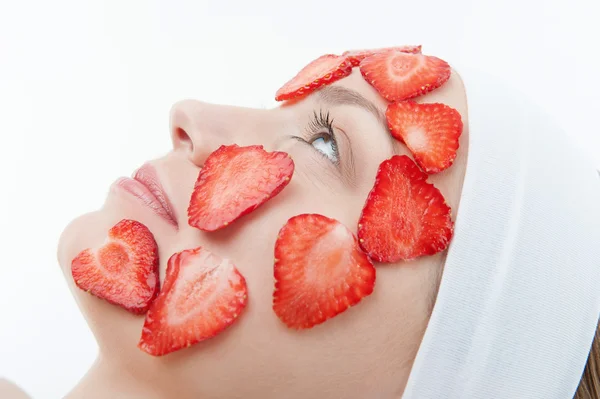 Mooie jonge vrouw ontvangen gezichtsmasker van aardbei in bea — Stockfoto