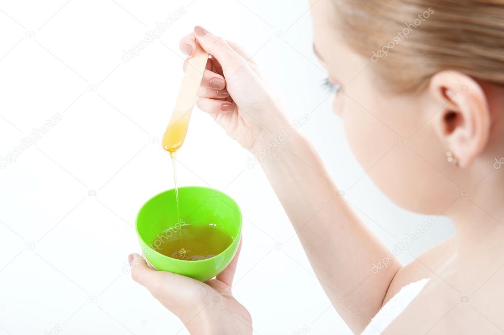 Woman preparing  homemade  facial mask of honey