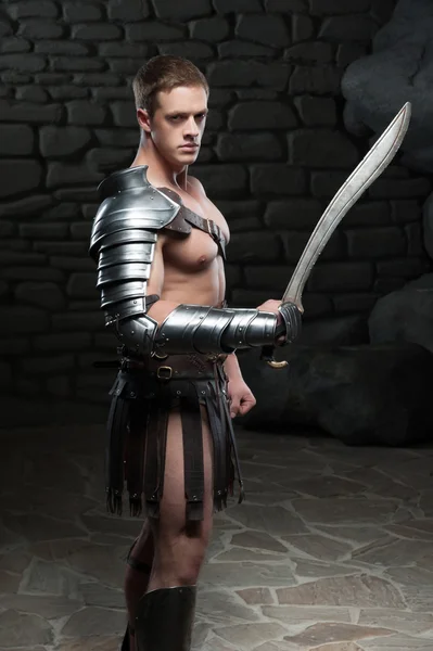 Gladiator with sword posing — Stock Photo, Image