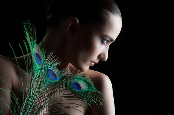 Beautiful brunette young woman with peacock style make-up and pe — Stock Photo, Image