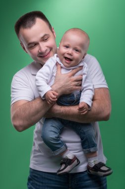 Onun bebek çocuk kucaklayan mutlu gülümseyen baba