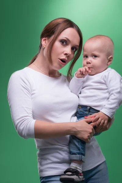 Young mother and her toddler son pointing at something — Stock Photo, Image