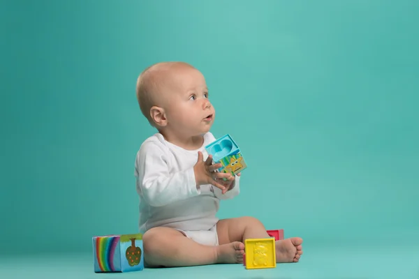 Little cute baby boy playing with color blocks — Stock Photo, Image