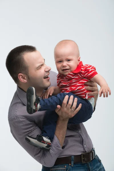 Cute toddler boy is naughty on dads hands — Stock Photo, Image