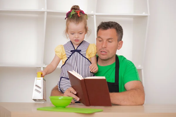 Family concept, cute little girl with father preparing to cook — Stock Photo, Image