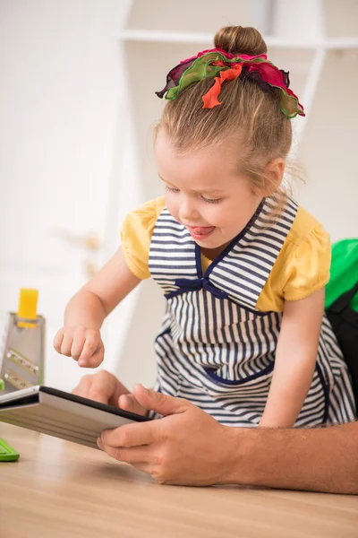 Closeup portrait of cute little girl with tablet cooking — Stock Photo, Image
