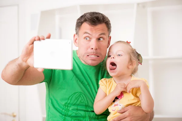 Отец и ребенок с помощью электронного планшета дома — стоковое фото
