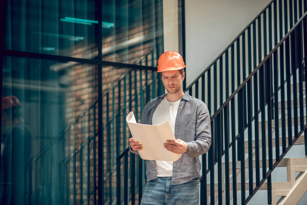 Man looking at sketch on paper in hands