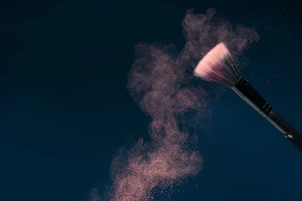 Professional black make-up brush with pink powder in motion isol — Stock Photo, Image