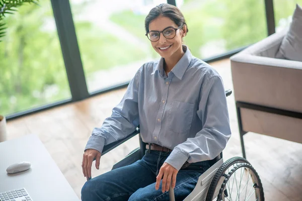 A disabled young woman looking contented and smiling nicely — Stock Photo, Image