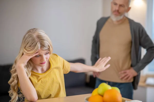 A blonde cute girl feeling frustrated while her father shouting at her — Stock Photo, Image