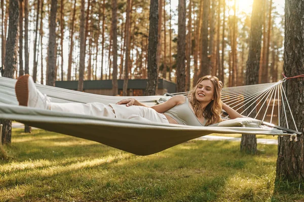 Woman in pensive mood relaxing on hammock — Stock Photo, Image