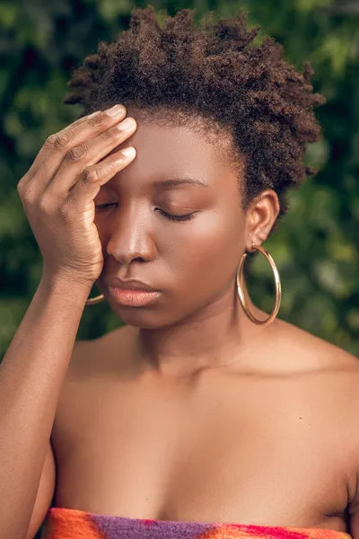 En mörkhyad kvinna som lider av huvudvärk — Stockfoto