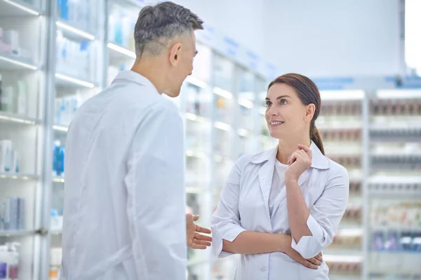 Hombre y mujer hablando en la farmacia —  Fotos de Stock