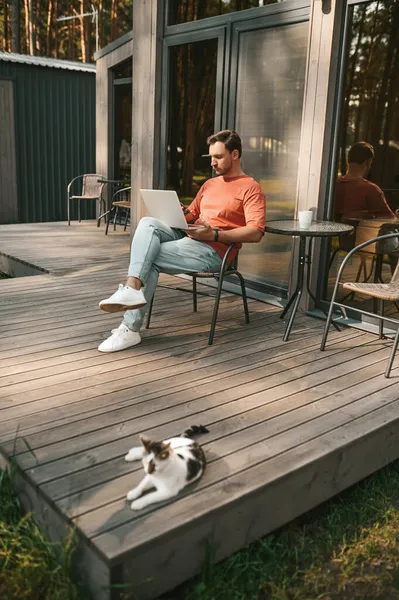 Άνθρωπος με φορητό υπολογιστή κάθεται σε εξωτερικούς χώρους αναψυχής — Φωτογραφία Αρχείου