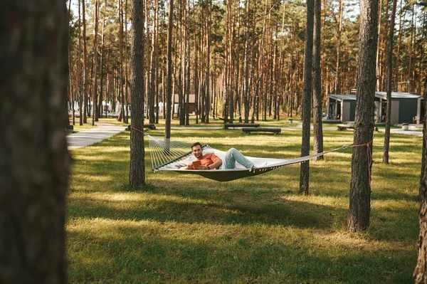 Smiling man with tablet relaxing in hammock — Stock Photo, Image