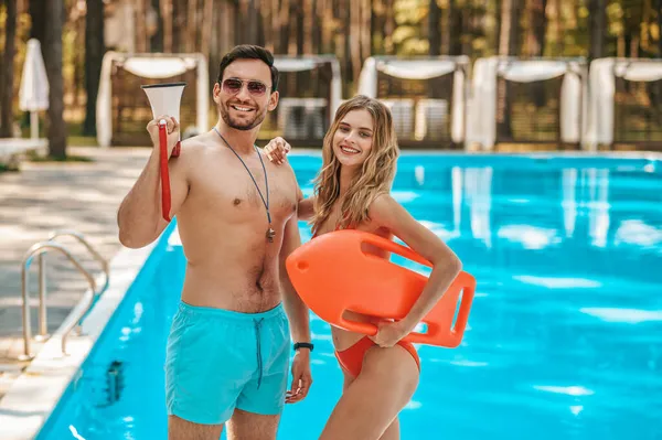 Two pool lifeguards standing near the public pool — Stock Photo, Image