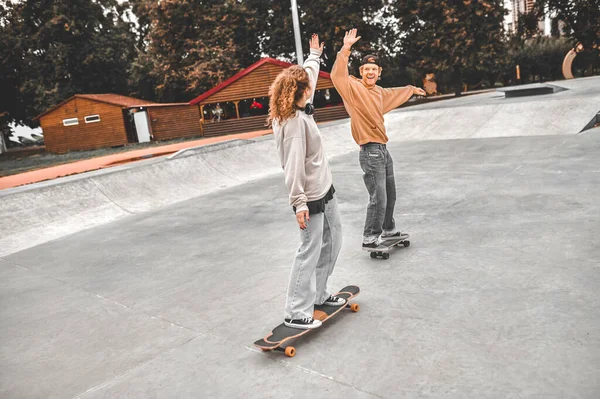 Guy και κορίτσι ολίσθηση για skateboards με έθεσε χέρι — Φωτογραφία Αρχείου