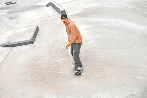 Top view of guy riding skateboard in skatepark