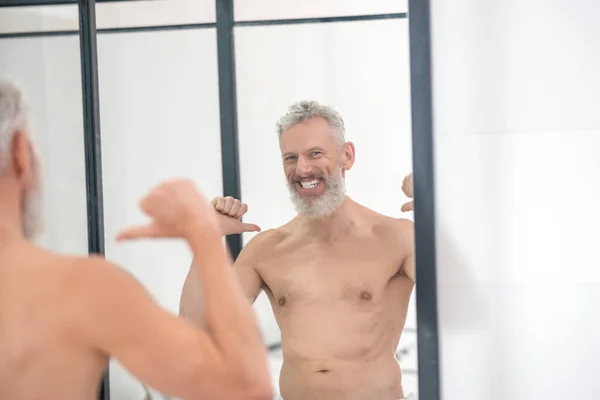 Reflectie in spiegel van lachende topless man — Stockfoto