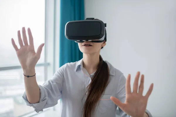 Žena hráč v VR brýle stojící v místnosti — Stock fotografie