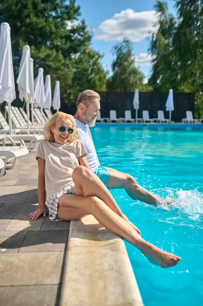 Couple d'âge mûr profitant du beau temps près de la piscine — Photo