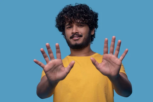 Cute guy with curly hair showing the Stop gesture — Stock Photo, Image