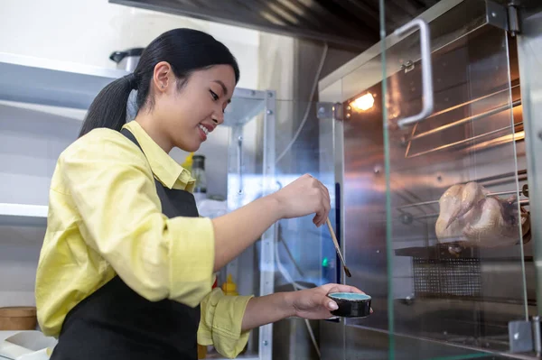 Asiática joven trabajando en la cocina y la preparación de alimentos — Foto de Stock