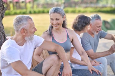 Antrenmandan sonra dinlenen ve neşeli hisseden bir grup insan.