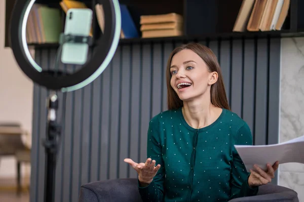 Excited young woman conducting an online tutorial — Stock Photo, Image