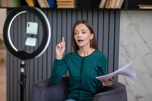 Excited young woman conducting an online tutorial — Stock Photo, Image