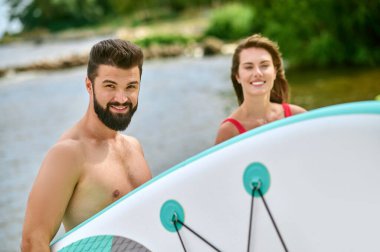 Kumsalda kanoları olan mutlu bir çift.