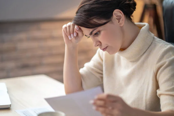 Femme d'affaires concentrée penchée sur un contrat — Photo