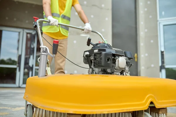 Workman applying a road sweeper on the construction site — Stock Photo, Image