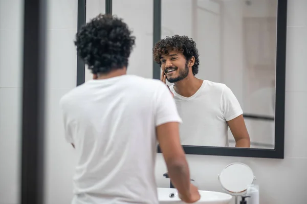 Pleased young male admiring his good looks — Stock Photo, Image