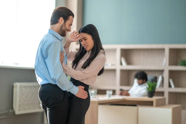 Man beter sig olämpligt med sin kvinnliga kollega på kontoret — Stockfoto