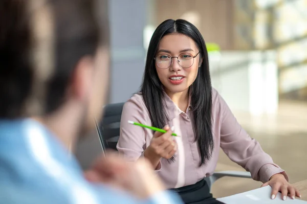 Equipo de negocios sentado en la mesa y discutiendo detalles del proyecto — Foto de Stock