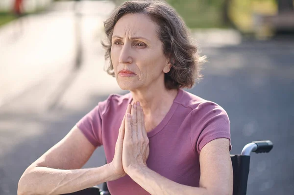 Серьезный стресс женщина, держась за руки в молитвенном жесте — стоковое фото