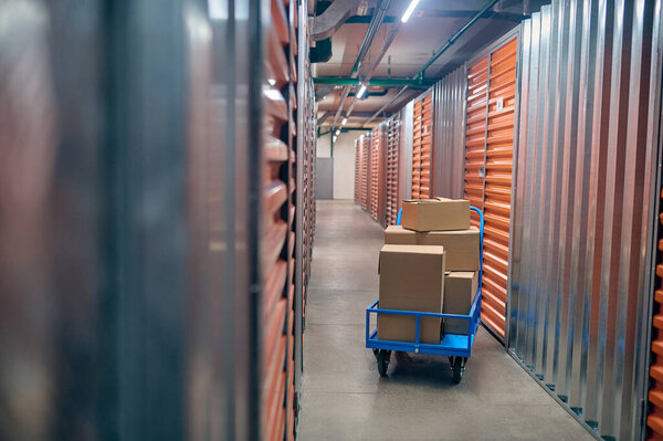 Boxed items stacked on the platform cart in the warehouse