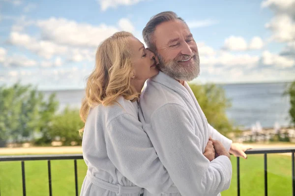 A couple at the balcony hugging and feeling amazing — Stock Photo, Image