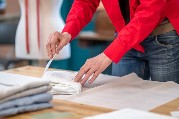 Mãos de mulher tocando papel de embrulho na mesa — Fotografia de Stock