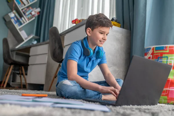 Niño enfocado trabajando en su portátil durante sus estudios — Foto de Stock